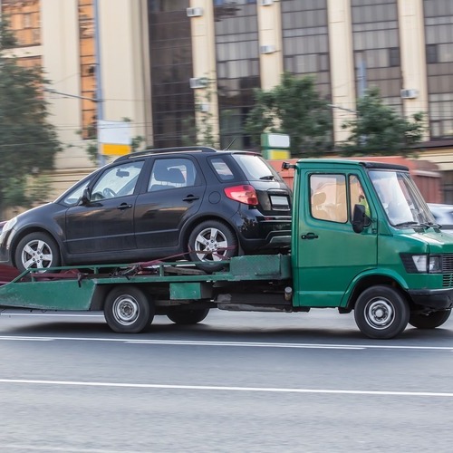 a tow truck towing a car